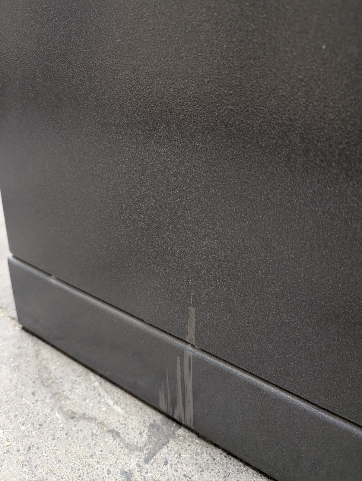 Blemished AMSEC NF5924E5 paint scrape on left side of safe near bottom, mostly on removable shipping skid. 